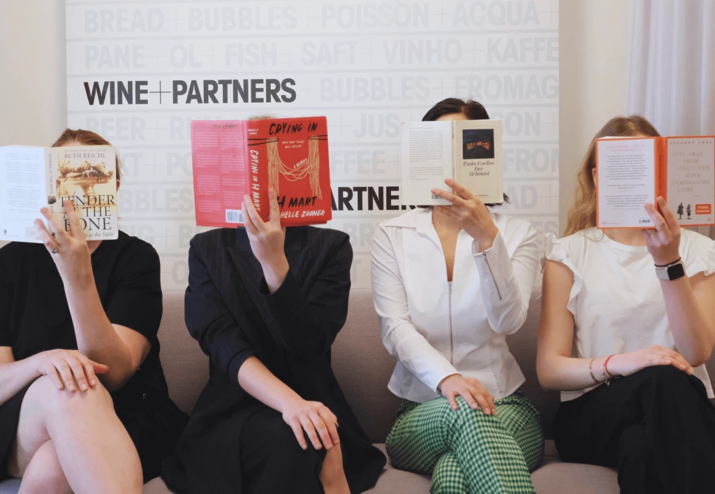 Vier Wine+Partners-Mitarbeiterinnen beim Lesen